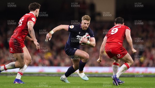 210226 - Wales v Scotland, 2026 Guinness Six Nations - Kyle Steyn of Scotland takes on Tomos Williams of Wales and Louis Rees-Zammit of Wales