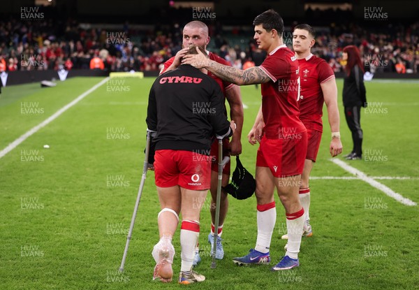 210226 - Wales v Scotland, 2026 Guinness Six Nations - Sam Costelow of Wales is consoled by Nicky Smith of Wales and Louis Rees-Zammit of Wales at the end of the match