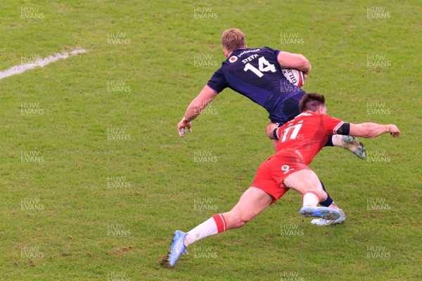 210226 - Wales v Scotland - Guinness Six Nations - Josh Adams of Wales tackles Kyle Steyn of Scotland