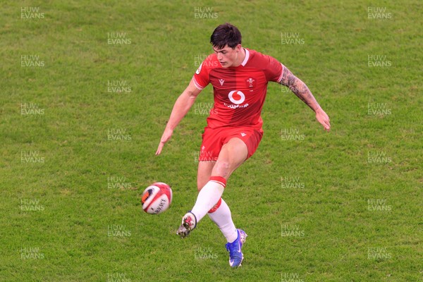 210226 - Wales v Scotland - Guinness Six Nations - Louis Rees-Zammit of Wales kicks the ball