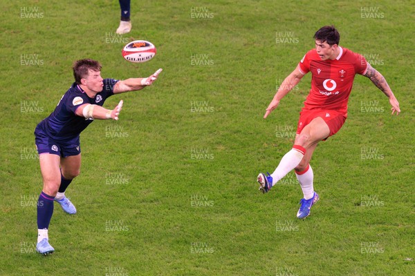 210226 - Wales v Scotland - Guinness Six Nations - Louis Rees-Zammit of Wales kicks the ball