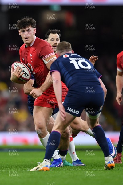 210226 - Wales v Scotland - Guinness Men's Six Nations - Eddie James of Wales is challenged by Finn Russell of Scotland