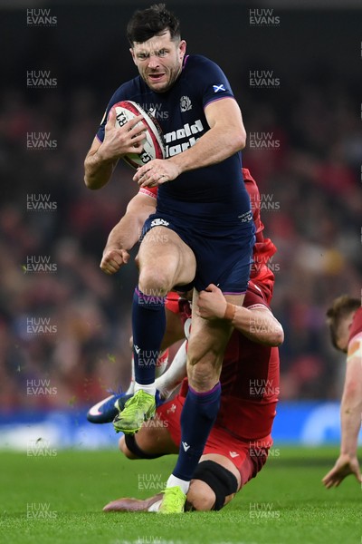 210226 - Wales v Scotland - Guinness Men's Six Nations - Blair Kinghorn of Scotland is challenged by Alex Mann of Wales
