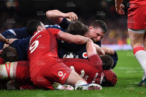 210226 - Wales v Scotland - Guinness Men's Six Nations - Scotland players celebrate after George Turner of Scotland pushes the ball over to score a try