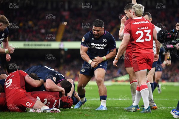 210226 - Wales v Scotland - Guinness Men's Six Nations - Sione Tuipulotu of Scotland celebrates after  George Turner of Scotland pushes the ball over to score a try