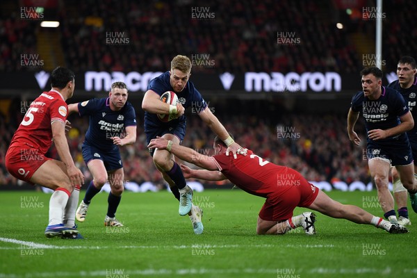 210226 - Wales v Scotland - Guinness Men's Six Nations - Kyle Steyn of Scotland is challenged by Dewi Lake of Wales
