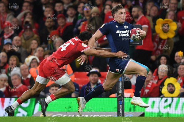 210226 - Wales v Scotland - Guinness Men's Six Nations - Kyle Steyn of Scotland is challenged by Gabriel Hamer-Webb of Wales