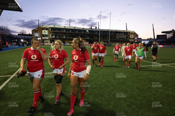230324 - Wales v Scotland, Guinness Women’s 6 Nations - Carys Phillips of Wales, Alex Callender of Wales and Georgia Evans of Wales leave the pitch at the end of the match