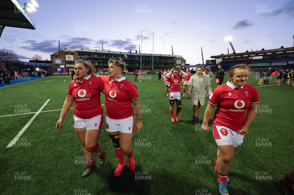 230324 - Wales v Scotland, Guinness Women’s 6 Nations - Gwenllian Pyrs of Wales, Donna Rose of Wales and Lleucu George of Wales leave the pitch at the end of the match