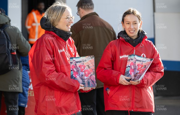230324 - Wales v Scotland, Guinness Women’s 6 Nations - Copies of Women’s Health magazine featuring members of the Wales team are headed to fans as they enter the stadium