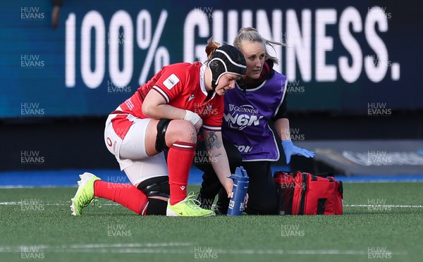 230324 - Wales v Scotland, Guinness Women’s 6 Nations - Bethan Lewis of Wales is treated by Jo Perkins, medic,  during the match