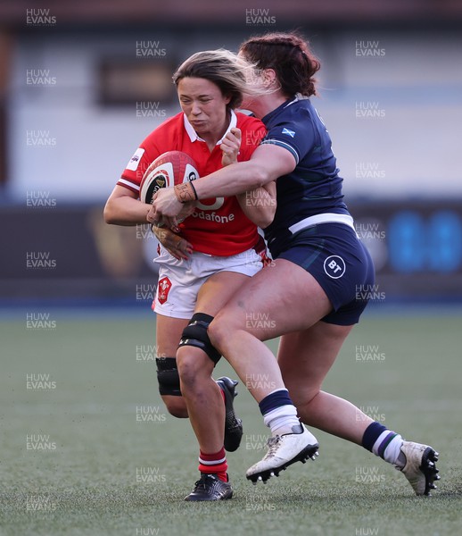 230324 - Wales v Scotland, Guinness Women’s 6 Nations - Alisha Butchers of Wales is tackled by Christine Belisle of Scotland