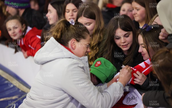 230324 - Wales v Scotland, Guinness Women’s 6 Nations - Natalia John of Wales signs autographs at the end of the match