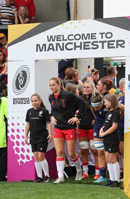 230825 - Wales v Scotland, Women’s Rugby World Cup - Lisa Neumann of Wales leads the team out on her 50th cap