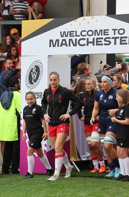 230825 - Wales v Scotland, Women’s Rugby World Cup - Lisa Neumann of Wales leads the team out on her 50th cap
