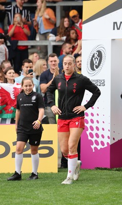230825 - Wales v Scotland, Women’s Rugby World Cup - Lisa Neumann of Wales leads the team out on her 50th cap