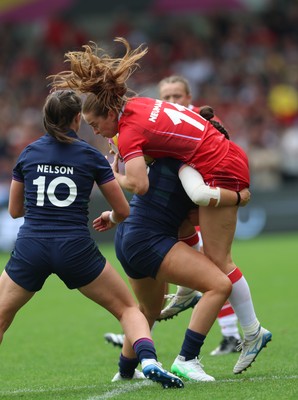 230825 - Wales v Scotland, Women’s Rugby World Cup - Lisa Neumann of Wales is tackled