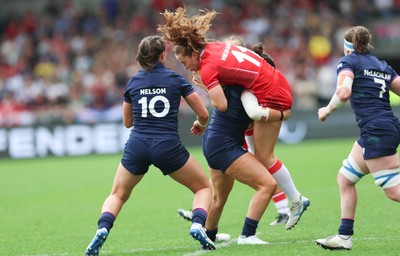 230825 - Wales v Scotland, Women’s Rugby World Cup - Lisa Neumann of Wales is tackled