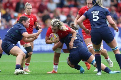 230825 - Wales v Scotland, Women’s Rugby World Cup - Alex Callender of Wales is tackled