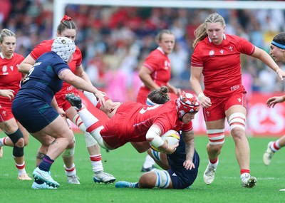 230825 - Wales v Scotland, Women’s Rugby World Cup - Donna Rose of Wales is tackled as she charges forward