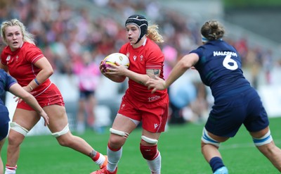 230825 - Wales v Scotland, Women’s Rugby World Cup - Bethan Lewis of Wales takes on Caity Mattinson of Scotland