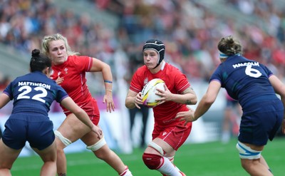 230825 - Wales v Scotland, Women’s Rugby World Cup - Bethan Lewis of Wales takes on Caity Mattinson of Scotland