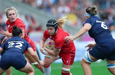 230825 - Wales v Scotland, Women’s Rugby World Cup - Bethan Lewis of Wales takes on Caity Mattinson of Scotland