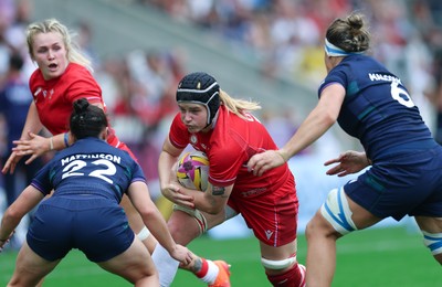 230825 - Wales v Scotland, Women’s Rugby World Cup - Bethan Lewis of Wales takes on Caity Mattinson of Scotland