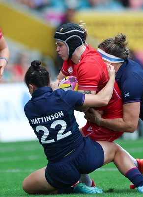 230825 - Wales v Scotland, Women’s Rugby World Cup - Bethan Lewis of Wales takes on Caity Mattinson of Scotland