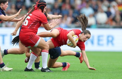 230825 - Wales v Scotland, Women’s Rugby World Cup - Nel Metcalfe of Wales is tackled
