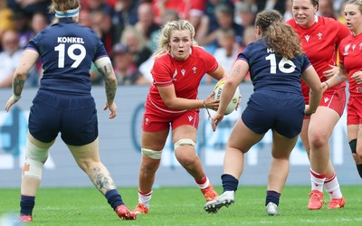 230825 - Wales v Scotland, Women’s Rugby World Cup - Alex Callender of Wales takes on Jade Konkel of Scotland and Elis Martin of Scotland