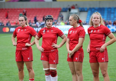 230825 - Wales v Scotland, Women’s Rugby World Cup - Courtney Keight of Wales, Bethan Lewis of Wales, Hannah Dallavalle of Wales and Carys Cox of Wales at the end of the match
