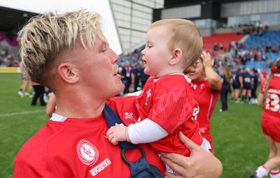 230825 - Wales v Scotland, Women’s Rugby World Cup - Donna Rose of Wales with daughter Margot at the end of the match