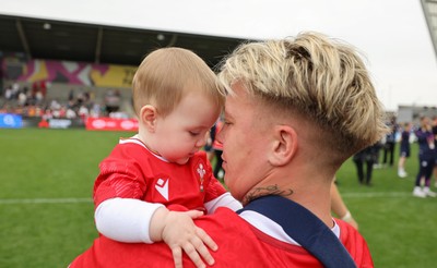230825 - Wales v Scotland, Women’s Rugby World Cup - Donna Rose of Wales with daughter Margot at the end of the match