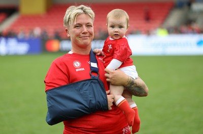 230825 - Wales v Scotland, Women’s Rugby World Cup - Donna Rose of Wales with daughter Margot at the end of the match