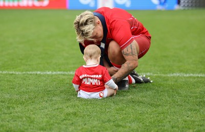 230825 - Wales v Scotland, Women’s Rugby World Cup - Donna Rose of Wales with daughter Margot at the end of the match