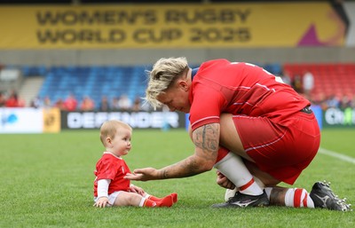 230825 - Wales v Scotland, Women’s Rugby World Cup - Donna Rose of Wales with daughter Margot at the end of the match