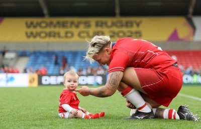 230825 - Wales v Scotland, Women’s Rugby World Cup - Donna Rose of Wales with daughter Margot at the end of the match
