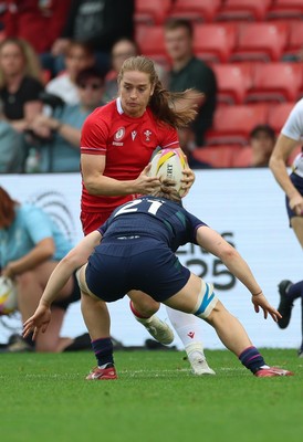 230825 - Wales v Scotland, Women’s Rugby World Cup - Lisa Neumann of Wales takes on Alex Stewart of Scotland