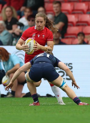 230825 - Wales v Scotland, Women’s Rugby World Cup - Lisa Neumann of Wales takes on Alex Stewart of Scotland