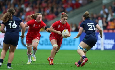 230825 - Wales v Scotland, Women’s Rugby World Cup - Kate Williams of Wales and Abbie Fleming of Wales take on Alex Stewart of Scotland