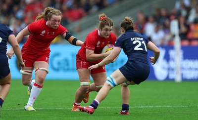 230825 - Wales v Scotland, Women’s Rugby World Cup - Kate Williams of Wales and Abbie Fleming of Wales take on Alex Stewart of Scotland