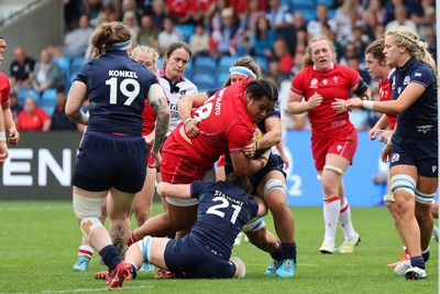 230825 - Wales v Scotland, Women’s Rugby World Cup - Sisilia Tuipulotu of Wales is tackled by Alex Stewart of Scotland