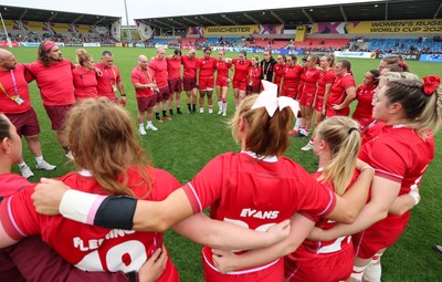 230825 - Wales v Scotland, Women’s Rugby World Cup - Wales team huddle together at the end of the match
