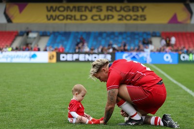 230825 - Wales v Scotland, Women’s Rugby World Cup - Donna Rose of Wales with daughter Margot at the end of the match