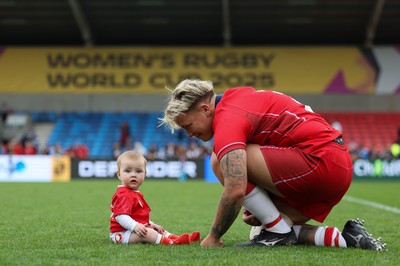 230825 - Wales v Scotland, Women’s Rugby World Cup - Donna Rose of Wales with daughter Margot at the end of the match