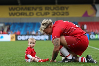 230825 - Wales v Scotland, Women’s Rugby World Cup - Donna Rose of Wales with daughter Margot at the end of the match