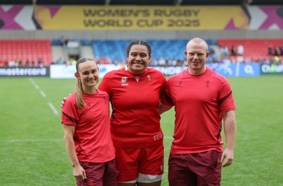 230825 - Wales v Scotland, Women’s Rugby World Cup - Sisilia Tuipulotu of Wales with Cara Jones, physio and Jamie Cox at the end of the match