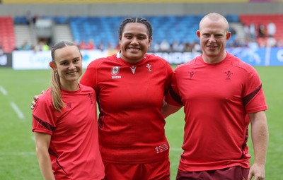 230825 - Wales v Scotland, Women’s Rugby World Cup - Sisilia Tuipulotu of Wales with Cara Jones, physio and Jamie Cox at the end of the match