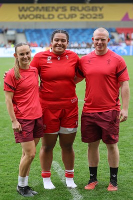 230825 - Wales v Scotland, Women’s Rugby World Cup - Sisilia Tuipulotu of Wales with Cara Jones, physio and Jamie Cox at the end of the match